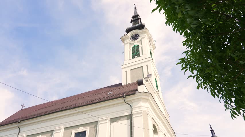 Low-angle view of the historic bell tower of a serbian orthodox church in Baja, Hungary