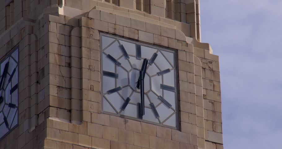shot of the clock on the clocktower of Woolworth building next to Blackpool Tower