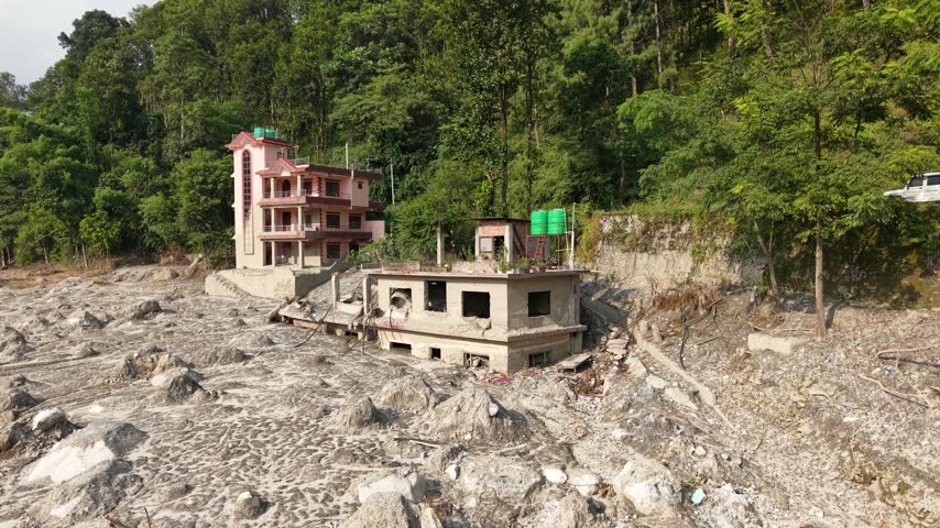 Footage shows the remains of a house in Betrawati Bazaar, nestled beside the mountains in Nepal, after the devastating Rasuwa flood of August 2026.