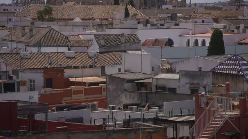 Elevated view of rooftops, La Giralda and Cathedral of Seville on a sunny day, Seville, Andalusia, Spain