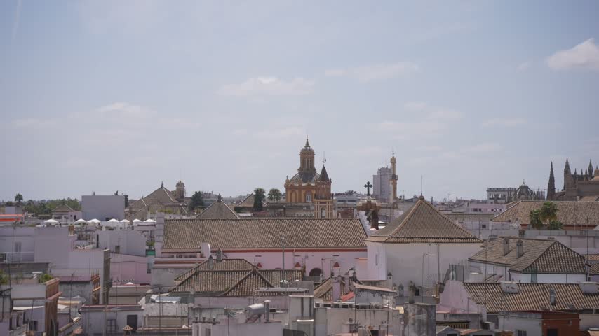 Elevated view of rooftops, La Giralda and Cathedral of Seville on a sunny day, Seville, Andalusia, Spain
