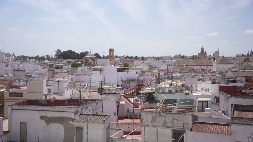 Elevated view of rooftops, La Giralda and Cathedral of Seville on a sunny day, Seville, Andalusia, Spain