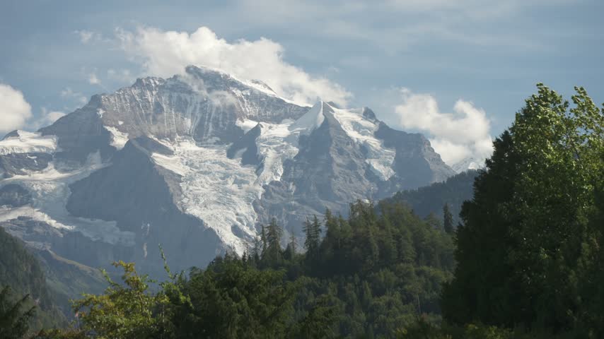 View of snow covered Alps from Interlaken on a sunny day, Unterseen, Interlaken, Bernese Alps, Switzerland