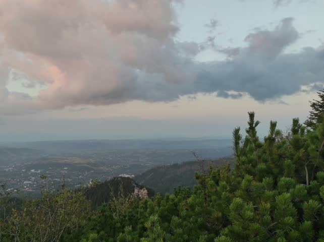 Scenic Green Hills Landscape Under Dramatic Sunset Sky