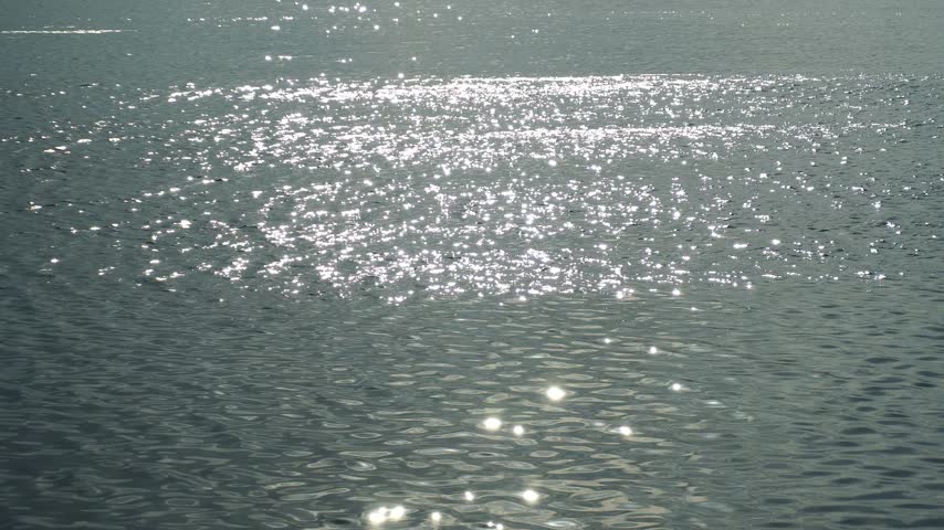 Amazing seascape view with sunrays over tranquil water surface.
