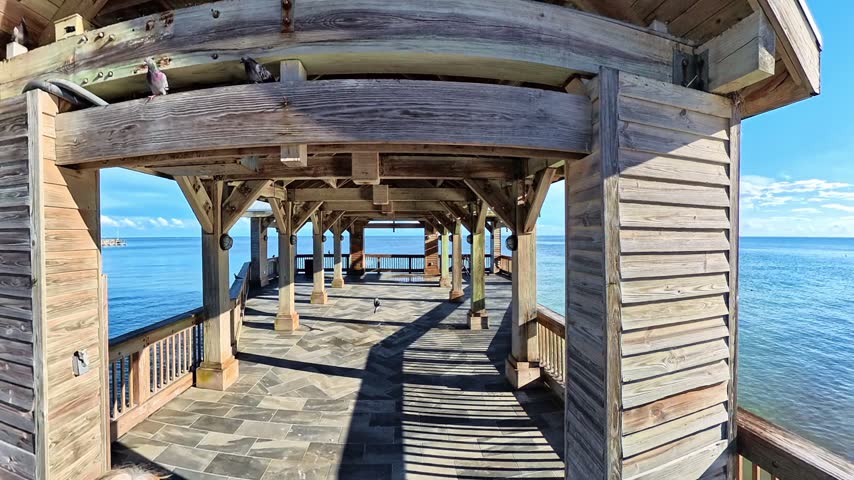 A coastal view reveals seaside pavilion with exposed timber beams in Key West Florida.