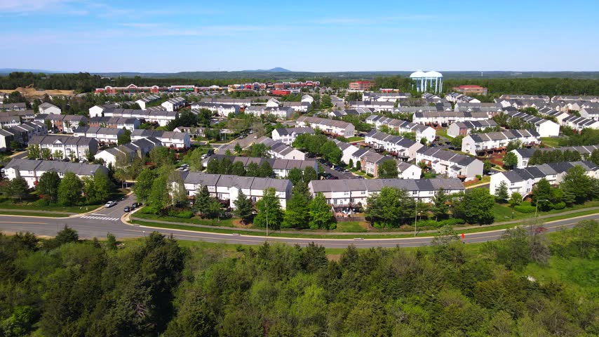 Aerial panorama reveals townhouse rooftops and landscaped neighborhoods in the Washington suburbs.