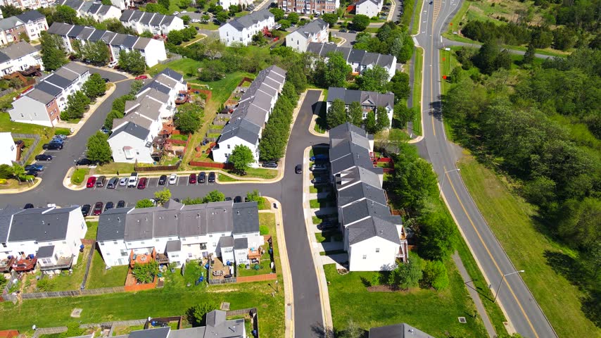 Townhouse blocks border a divided road through a residential suburb near Washington.