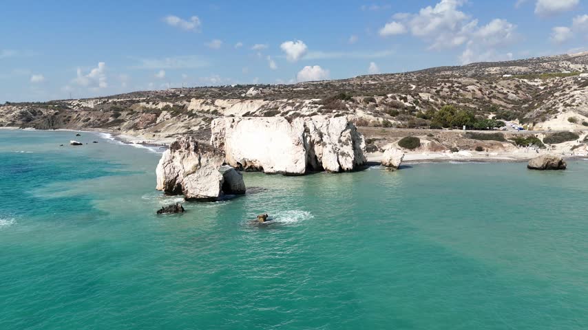 Drone shot of the famous Aphrodite beach in Cyprus with beautiful rock formations and blue water