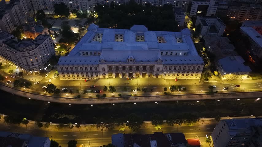 Night aerial view of Palace of Justice by Dambovita River in Bucharest, Romania
