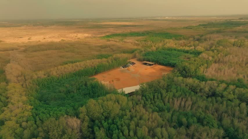 Aerial shot of a forest guest house near a village in Pakistan.