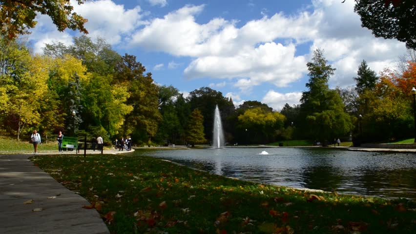 A setting of pond on a college campus.