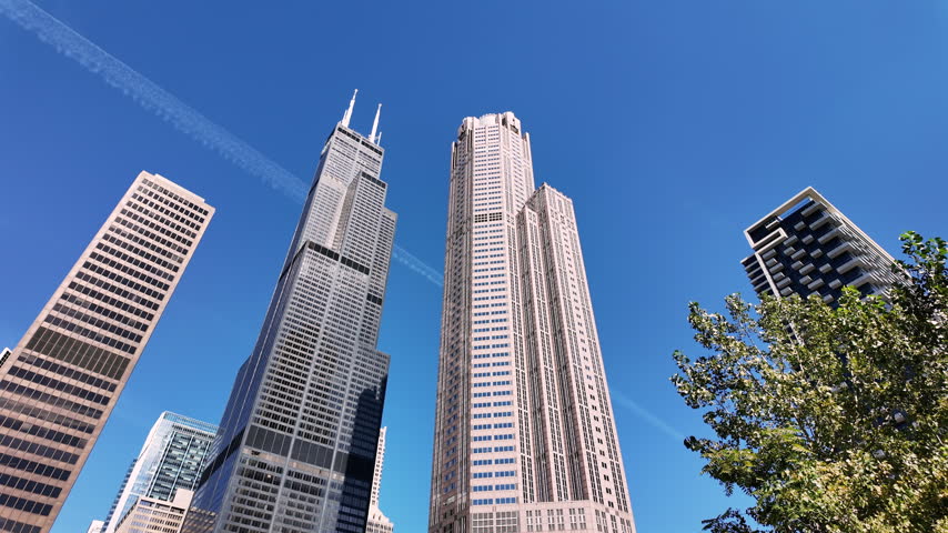 Looking up at dark and pink granite skyscrapers from a river boat in Chicago.