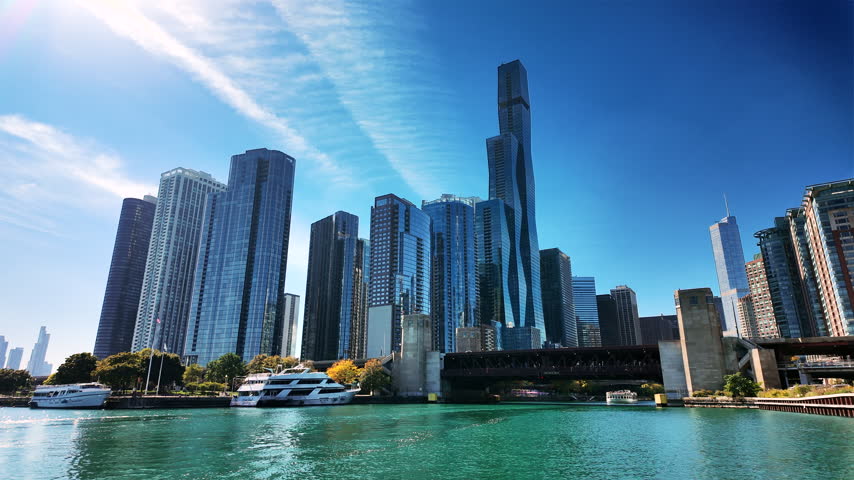 Lakefront skyline with a wavy glass tower and yachts at the river mouth, chicago.