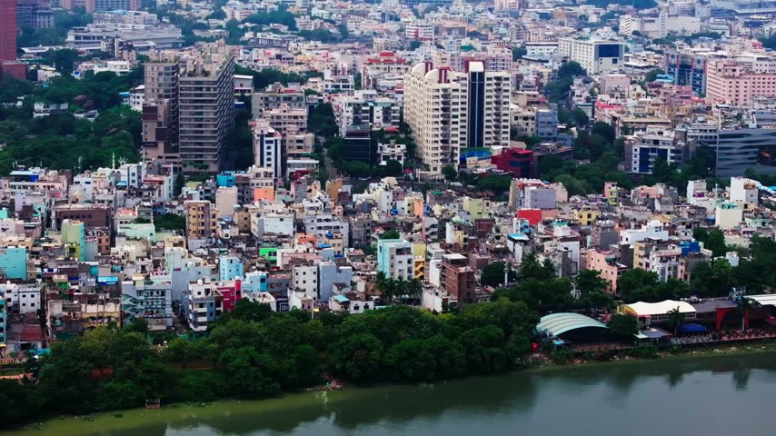 hussain sagar shore line with lake side restaurant, low rise buildings, skylines and THE PARK hotel at khairtabad, somajiguda, hyderabad, telangana, india. day time, pan shot, drone shot, 4k.
