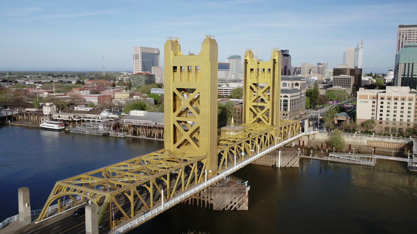 Drone Aerial Sweeping View of Sacramento Tower Bridge and Historic Riverfront Skyline - (4K UHD)