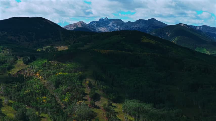 Aerial drone view of Beaver Creek Ski Resort ski trails lift lodge Mt of the Holy Crosssunny blue sky clouds sunny morning Fall Autumn Bachelor Gulch Vail Avon Colorado landscape circle right motion