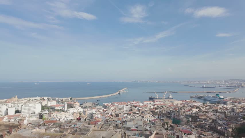 Beautiful aerial panoramic view of the city of algiers, algeria, showing the historic casbah, modern buildings, and the busy port on the mediterranean sea coast under a clear blue sky