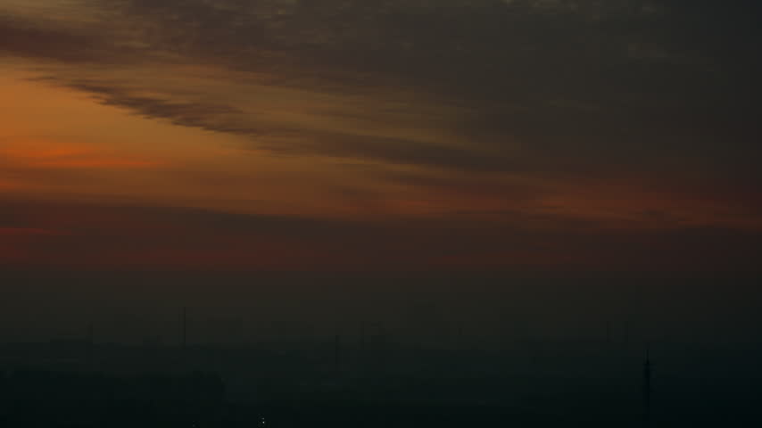 At sunset broad sheets of cloud are stained orange gold and stream away to one side