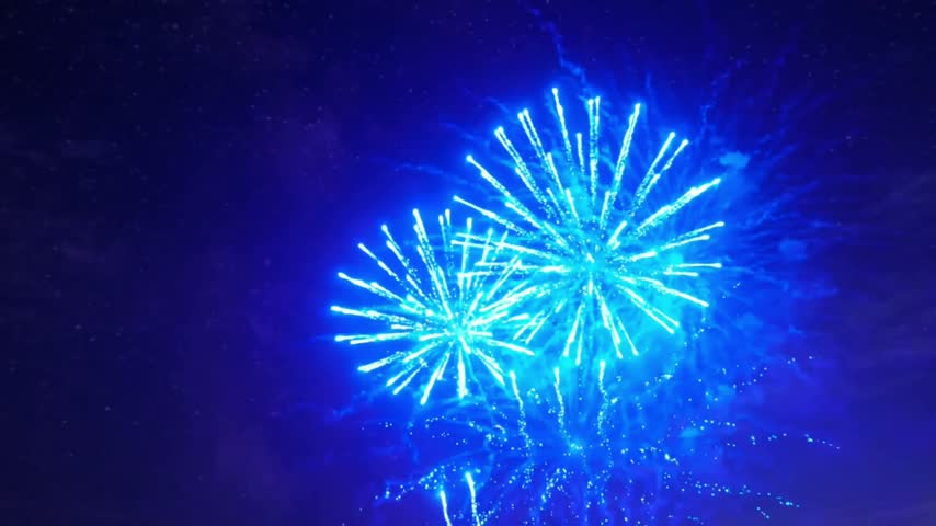 Bright blue firework explosion in the dark night sky for celebration