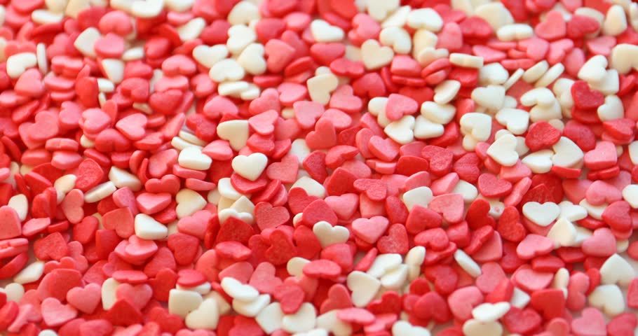 Confetti sprinkles in shape of heart. Decoration for dessert