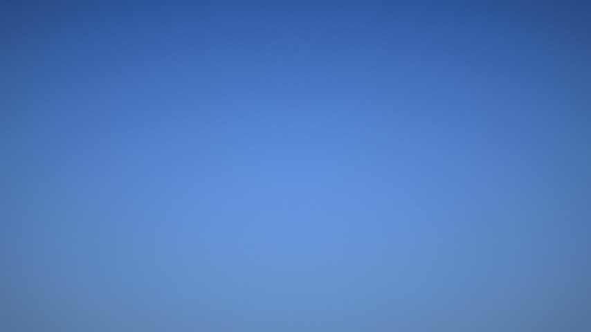Flock Of Geese Flying In V Formation Across Blue Sky, Migrating Geese In Migration Season