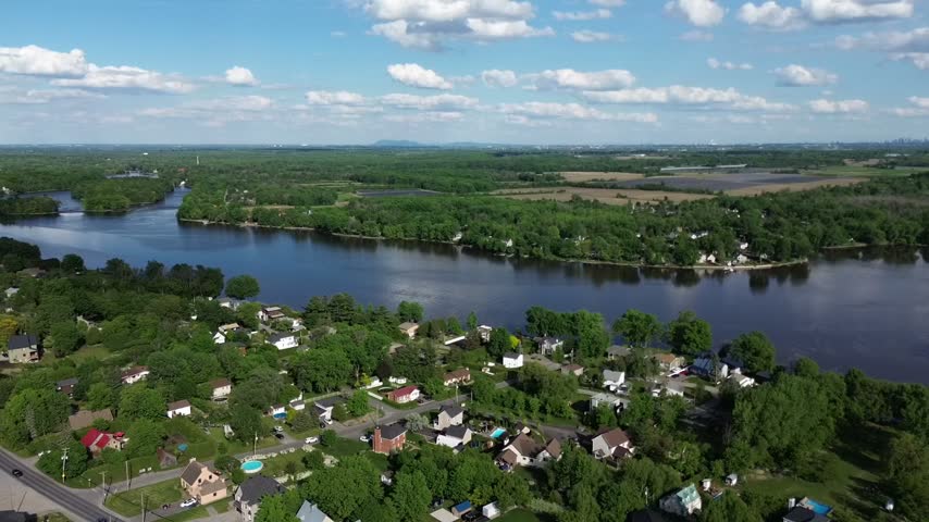 Aerial view of a riverside residential community in Quebec