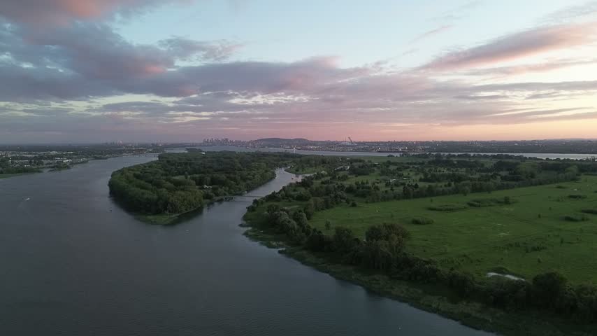 Winding river and green wetlands at sunset in Quebec