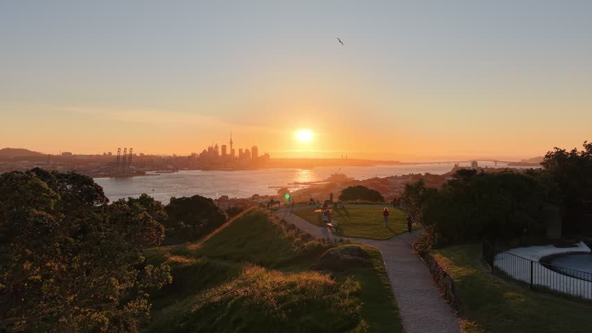 Aerial view of sun setting behind Auckland City in New Zealand