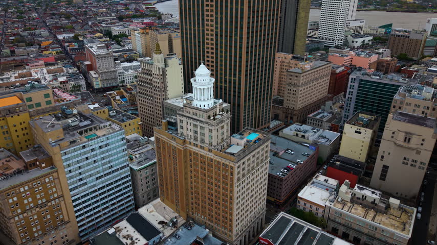 New Orleans, Louisiana with high-rise buildings, commercial district and waterfront infrastructure. Mississippi River creates dramatic backdrop for the city iconic skyline.