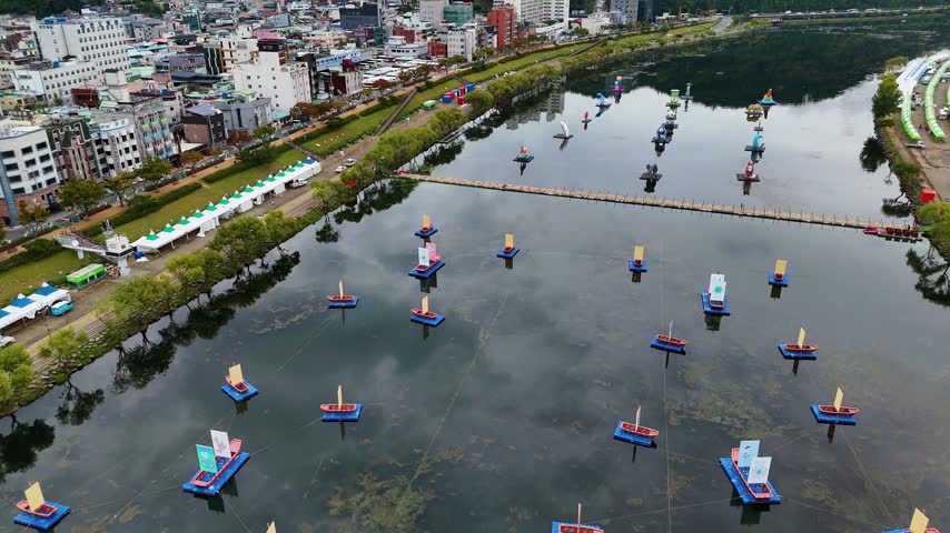 Aerial drone view capturing colorful floating lanterns installed along nam river during jinju namgang yudeung festival in south korea