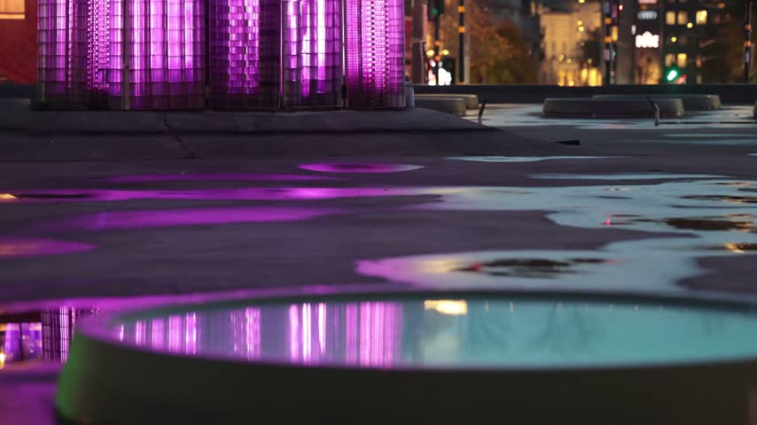 Stockholm, Sweden Puddle reflections at night in the fountain at Sergels Torg. 