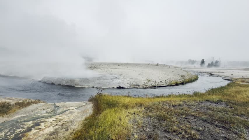 Steaming geothermal geyser basin in Yellowstone National Park, Wyoming