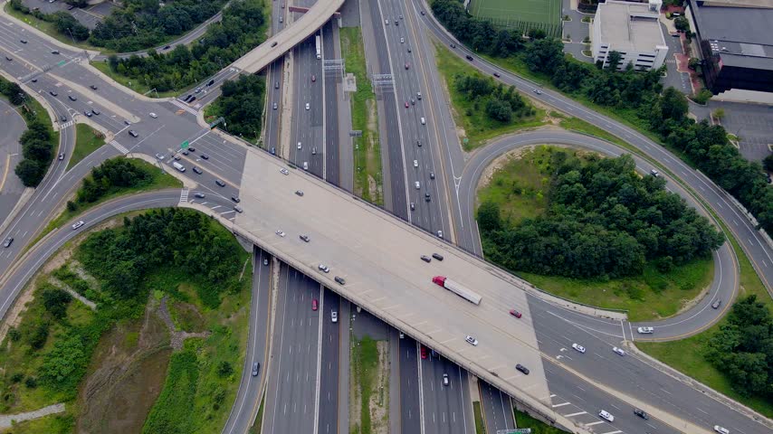 Aerial view shows a road bridge spanning a Tysons Virginia highway interchange.