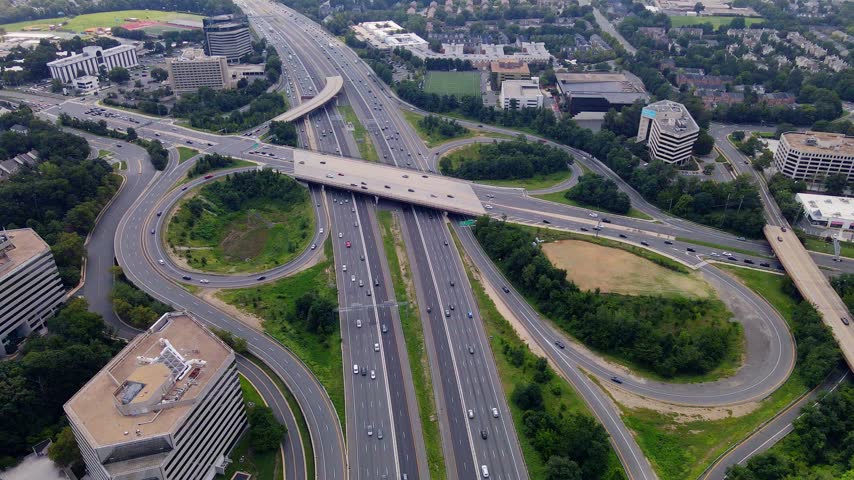 Curved ramps form loops beside a divided highway in Tysons Virginia.