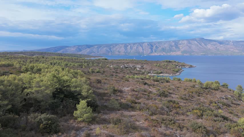 Aerial View of Hvar Coastline and Brac Mountains Across Adriatic Sea, Croatia