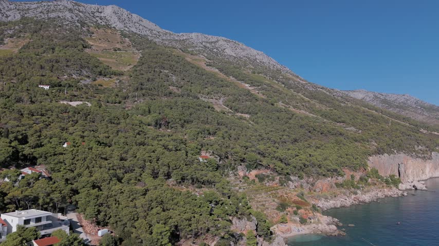 Aerial View of Hillside Village Beneath Limestone Cliffs on Hvar, Croatia