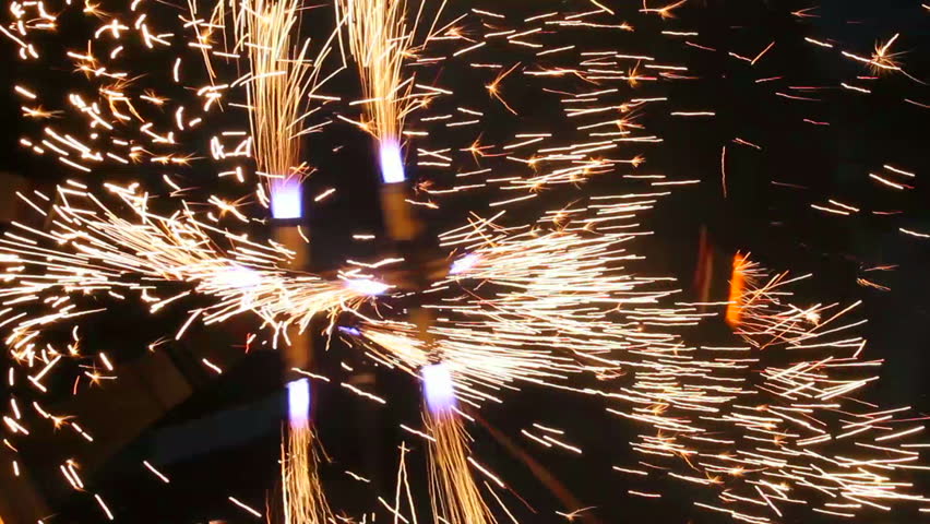 Sparks from fireshow, huge fire mill, flame artists, fireworks, celebration