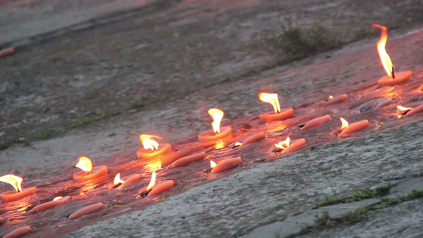 Burning memorial candles on concrete. Memory, mourning day