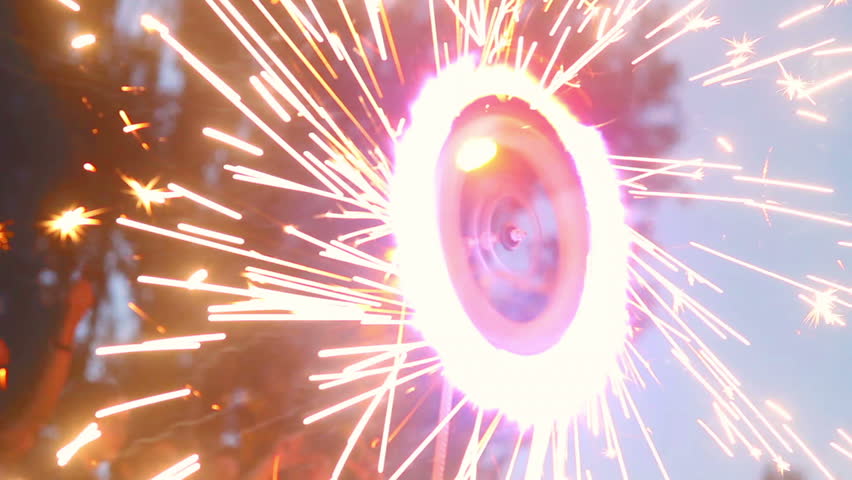 Spinning firework wheel, sparkles all around, fire show performance