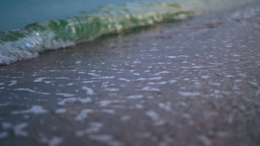 Small waves on sandy beach.