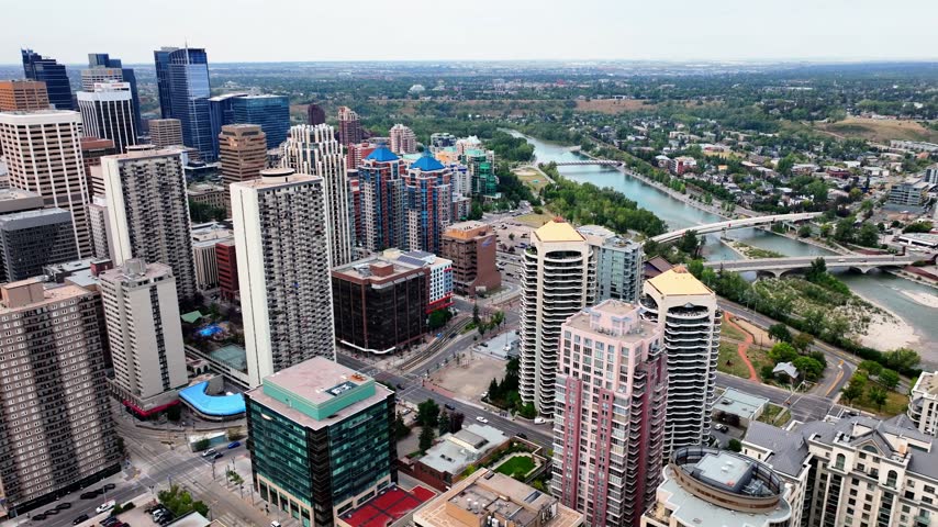 Aerial view of downtown Calgary skyscrapers, apartment towers and a river with bridges on a clear summer day, Calgary, Alberta, Canada