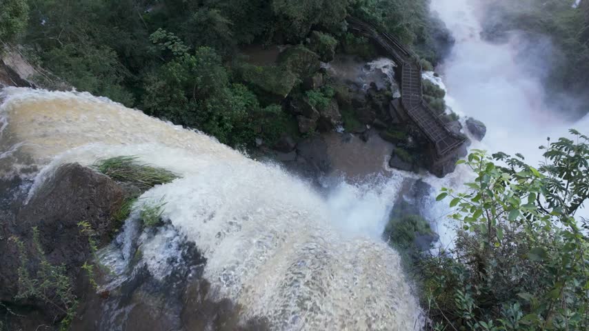 Top Down View Of Iguazu Falls With A Scenic Walking Platform And Rushing Water In Argentina