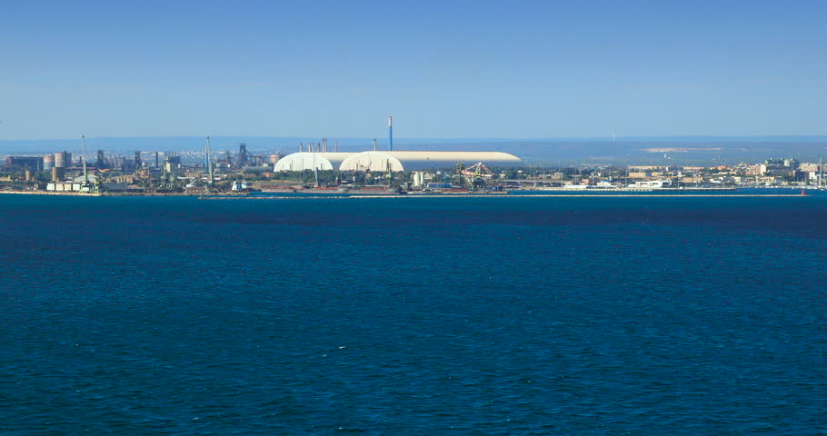 Taranto cityscape: view from sea of the historic center and the industrial area in Apulia, southern Italy.