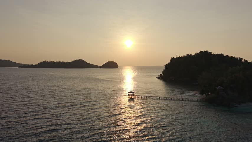 Aerial view of a tropical island sunset over the ocean