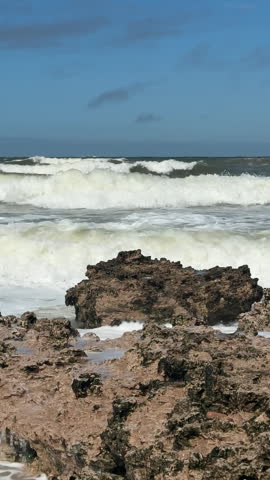 Slow Motion of Large Ocean Waves Crashing Against Rocky Shoreline in Atlantic Ocean