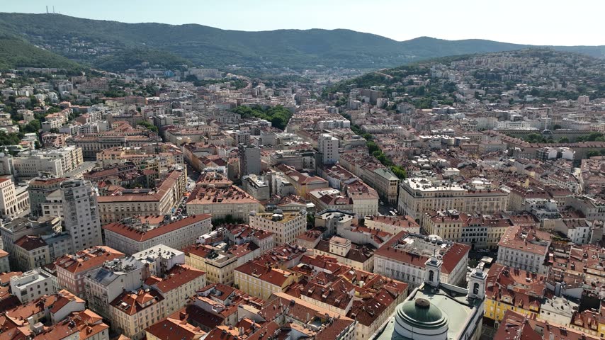 Aerial View of Historic City Center of Trieste, Italy. Nestled Between Lush Green Mountains and Adriatic Sea. Footage Captures Stunning Architecture, Vibrant Streets on a Sunny Autumn Day. Drone Shot