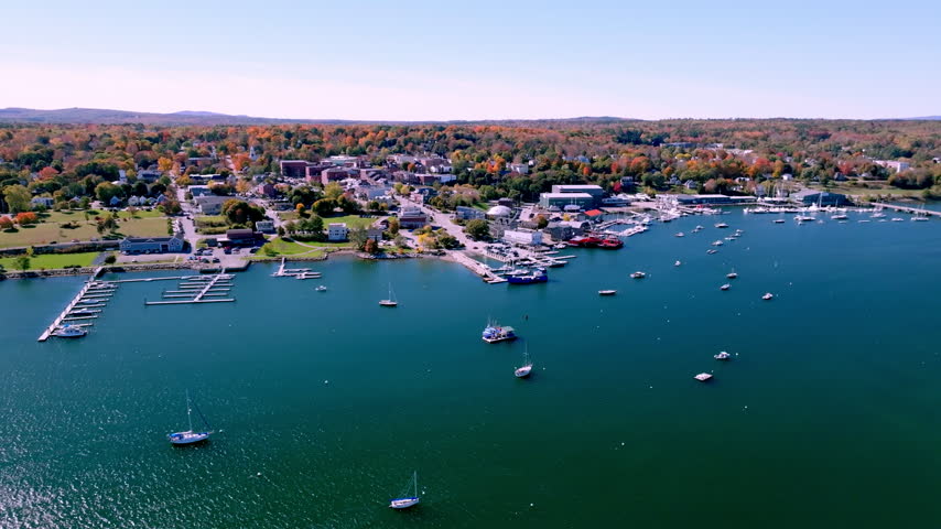 Downtown Belfast, Maine in fall color, with docks and moored boats on Penobscot Bay