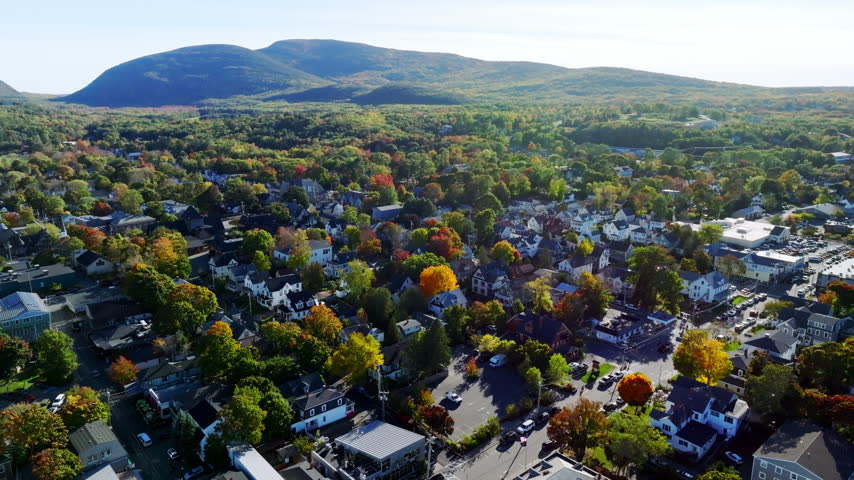 Bar Harbor village in peak fall color beneath the Acadia mountains, Maine