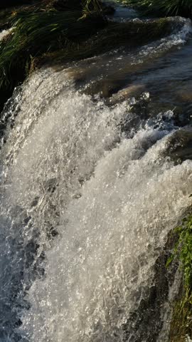 Vertical Slow Motion Footage of a Flowing Waterfall